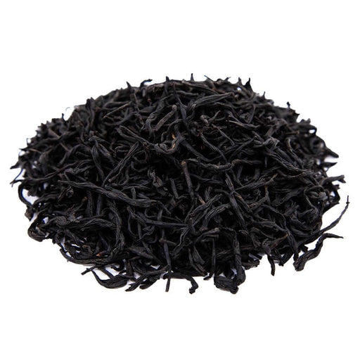 Side mound picture of The Whistling Kettle Secret Village black tea with long curled leaves.